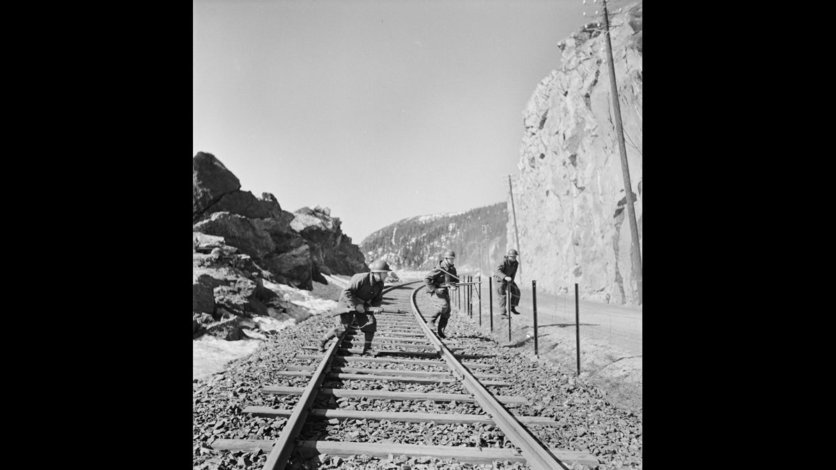 Campagne de Norvège. Des chasseurs alpins de la 1ère Division légère de chasseurs (DLCh) franchissent la voie ferrée qui relie Narvik à la région des mines de fer suédoises. / © Jean Manzon/Service cinématographique de la Marine/ECPAD/Défense/ MARINE 260-3634